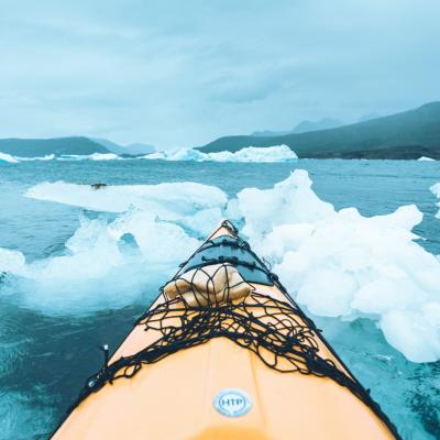 Kayaking among blue icebergs in South Greenland