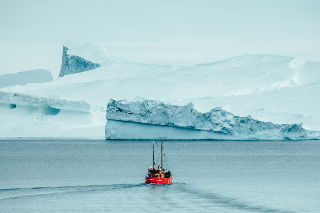 Sightseeing boat in Disko Bay approaching icebergs