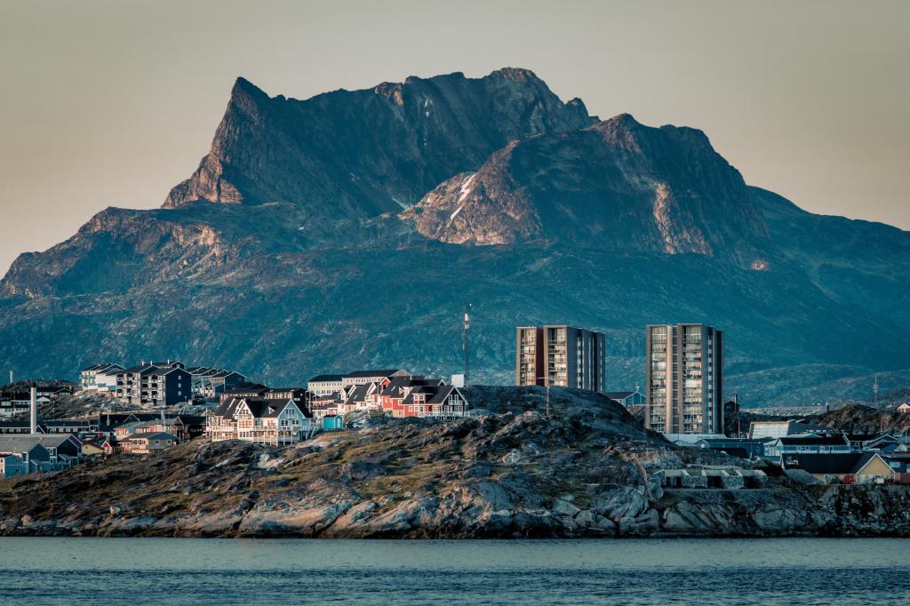 Buildings in Nuuk with the mountain Sermitsiaq in the background at sunset in Greenland