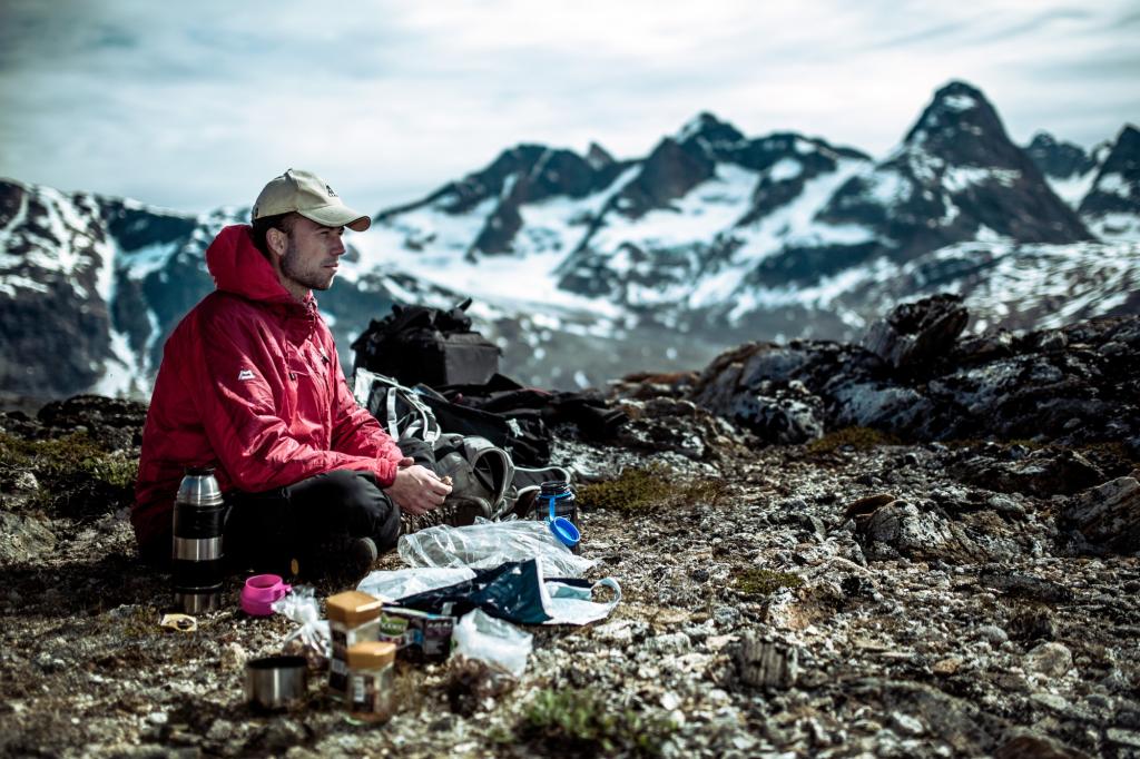 A guide making coffee for his guests on a trek near Tasiilaq in East Greenland